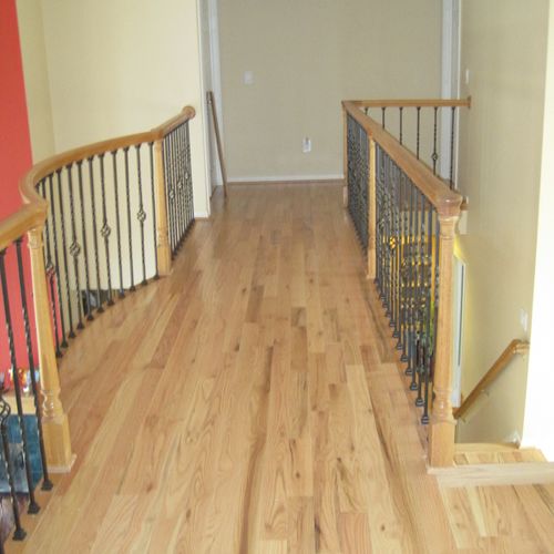 Install prefinish flooring with new railing/spindl