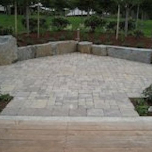 Stone look concrete pavers with basalt boulers and