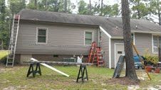 Back of House after recieveving new siding and isu