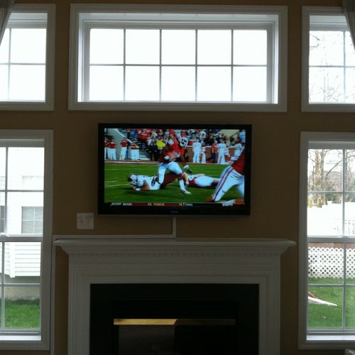 55" television over fire place the.