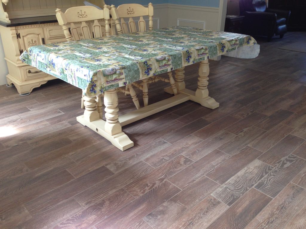 Beautiful, wood-look tile floor installed in Dinin