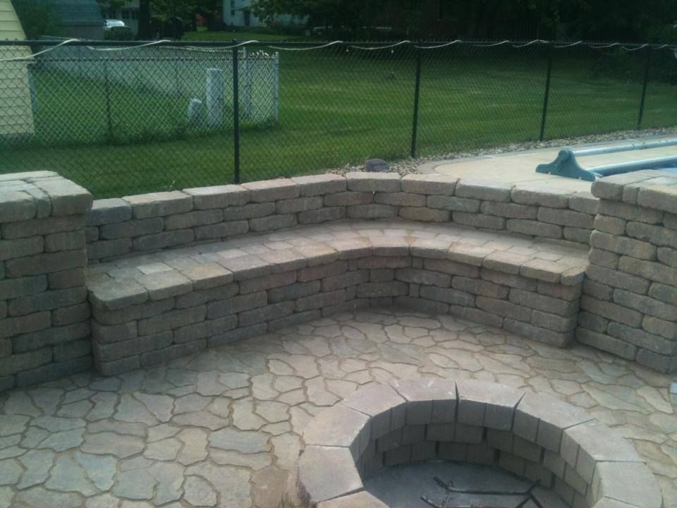 Closer view of the sitting wall, patio, and fire p