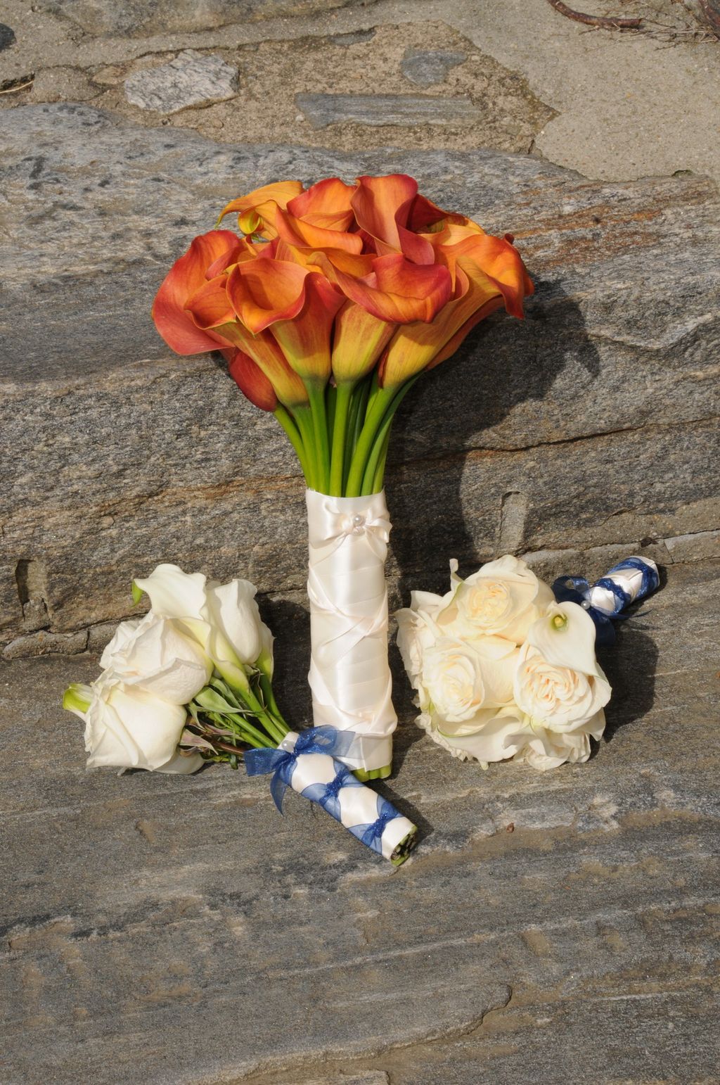 Mango colored calla lily bouquet with white vendel