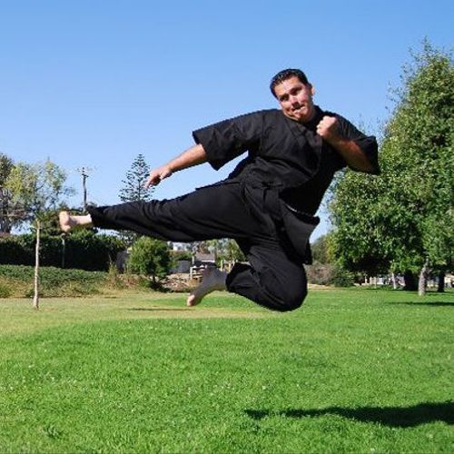 Lee Lollio performing a flying side jump kick.