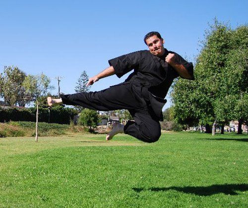 Lee Lollio performing a flying side jump kick.