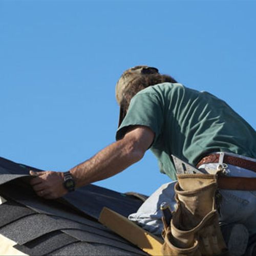 Frisco roofing experts hard at work replacing a ro