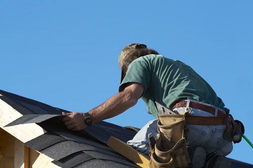 Frisco roofing experts hard at work replacing a ro