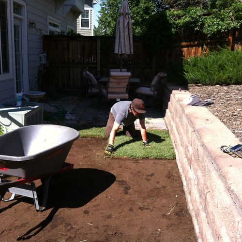 Scott installing first pieces of sod at a resident