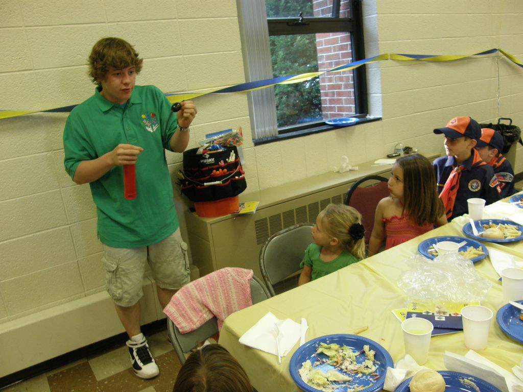 Balloon Artist Blake entertaining a table of Cub S