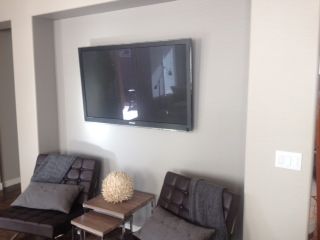 Wall mounting of 58" flat panel TV. Notice...no ex