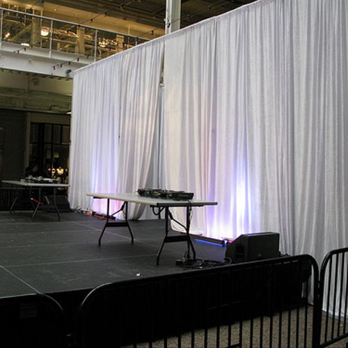 Stage rental set up with LED backlit pipe and drap