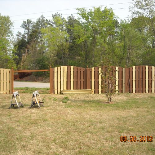 Repairing a tornado damaged privacy fence.