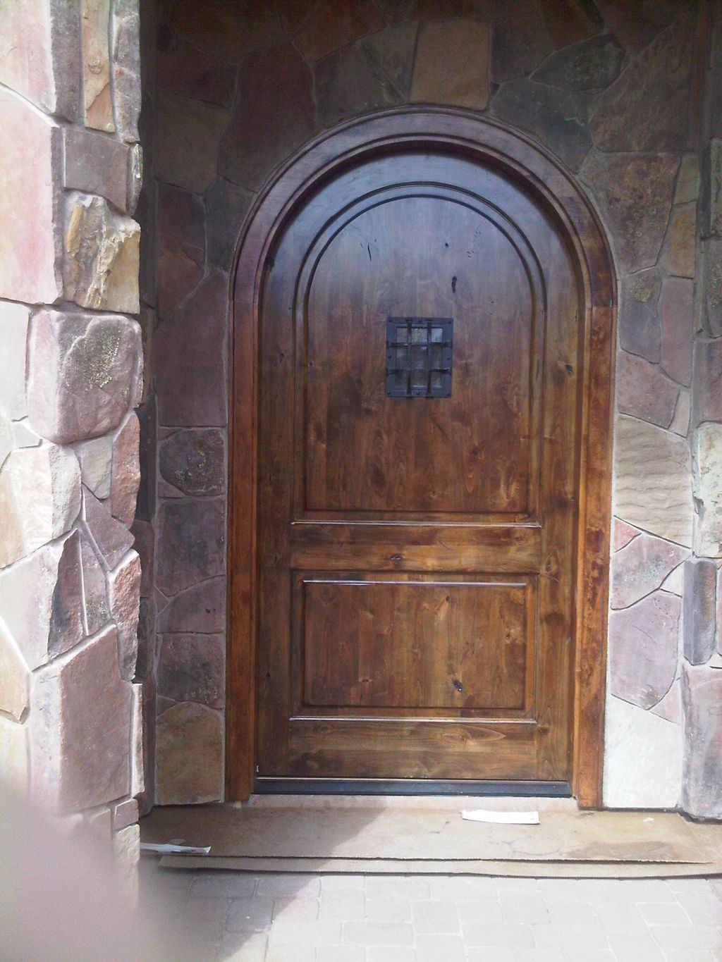 custom radius entry door and stone work