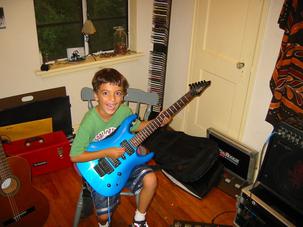 A happy student trying his hand at a full size ele