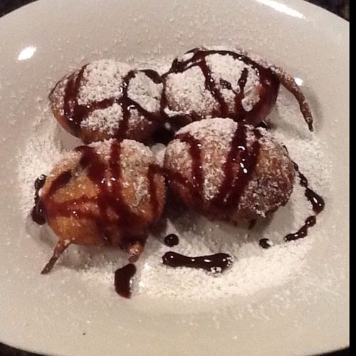 Fried Oreos with chocolate sauce and powder auger