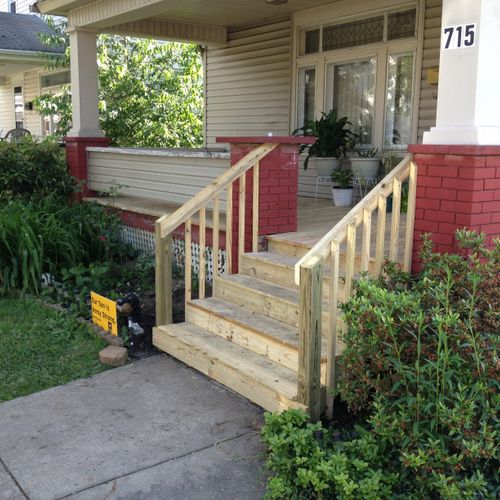 A porch rebuilt with new steps and handrails