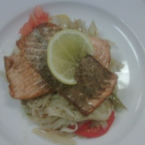 Seared Salmon Fillet on top of noddles with tri co