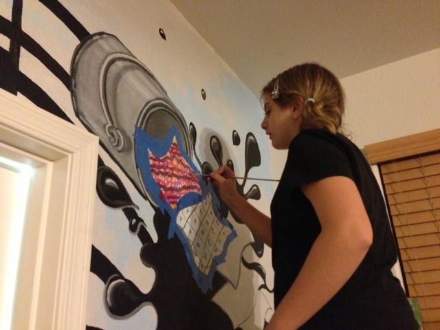 Child painting original piece on Musical Mural fam