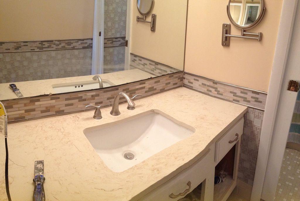 Tiled, painted, and replaced the vanity in this cl