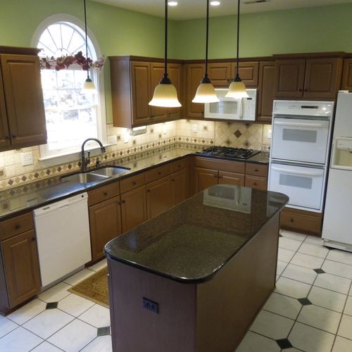 Refinished cabinets, granite countertops, new ligh