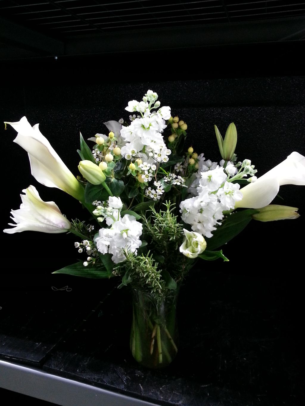 Monochromatic white arrangement in a glass vase.