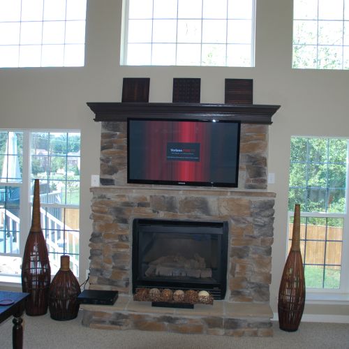 tv over stone fireplace