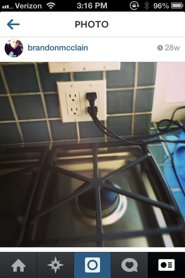 Receptacle dangerously placed behind stove top bur