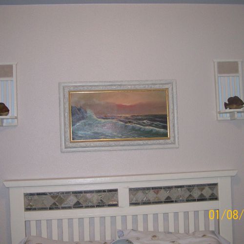 Headboard, wall sconces and picture frame