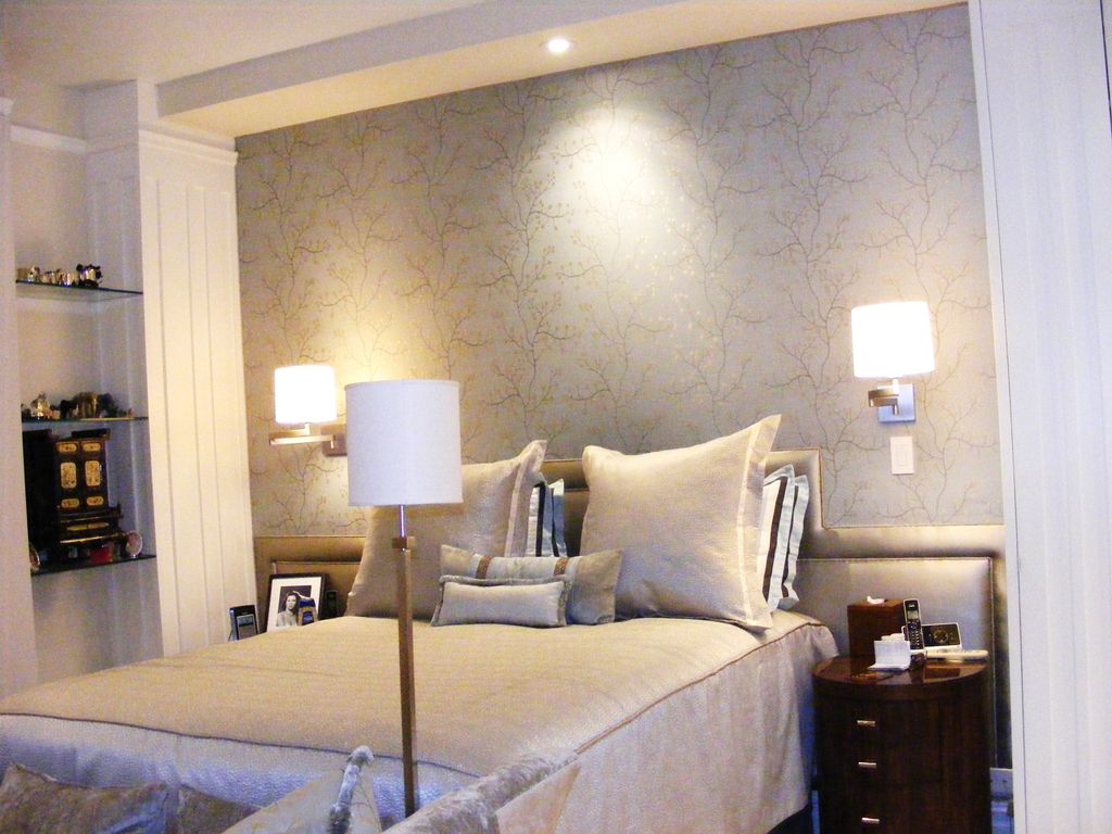 Wall upholstery, pillows, bedding and coverlet are