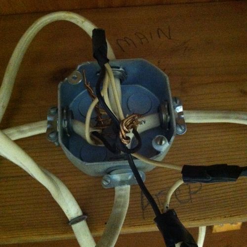 Open junction box found above a ceiling tile.