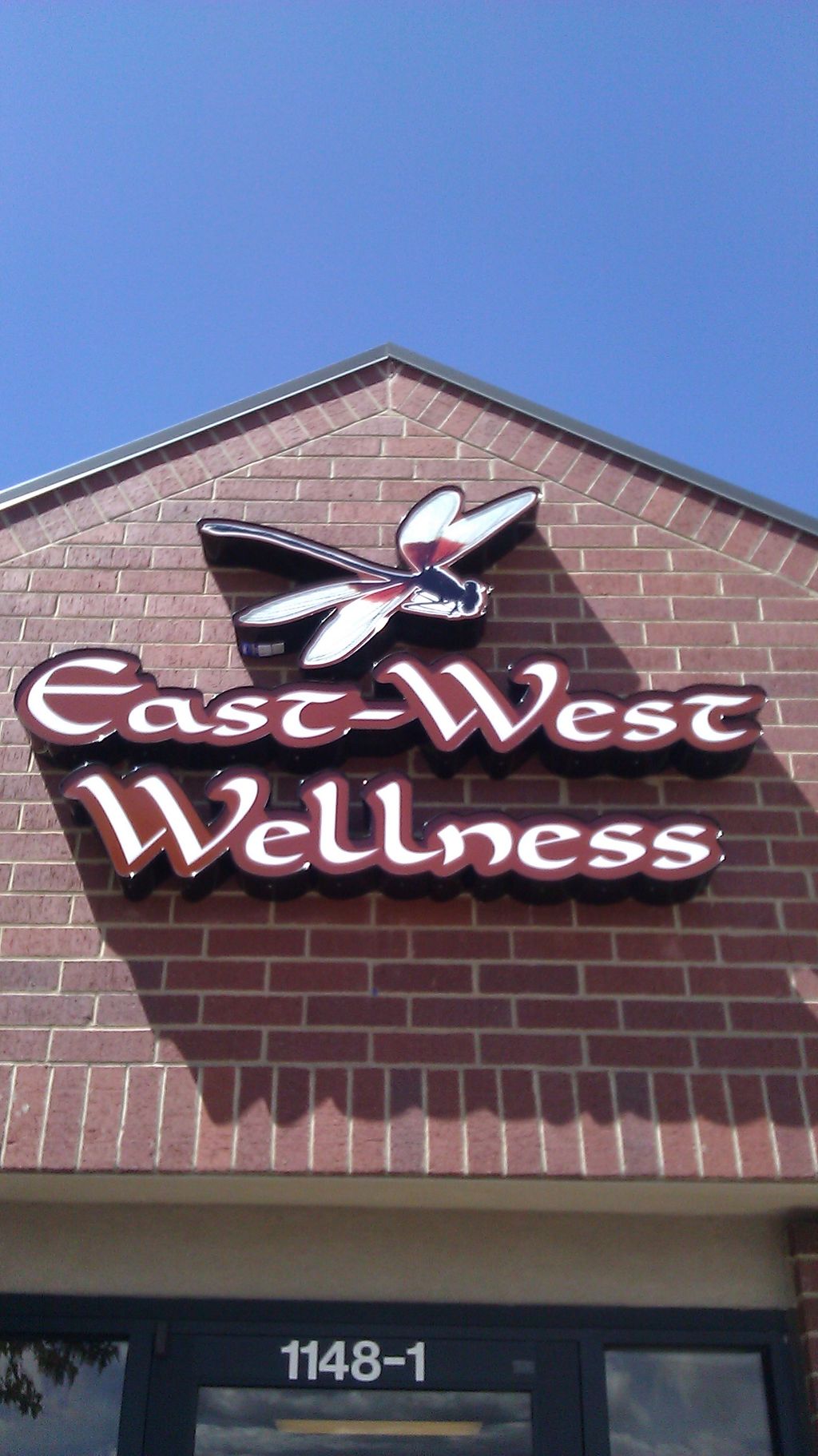 Our East-West Wellness logo on a sunny day!
