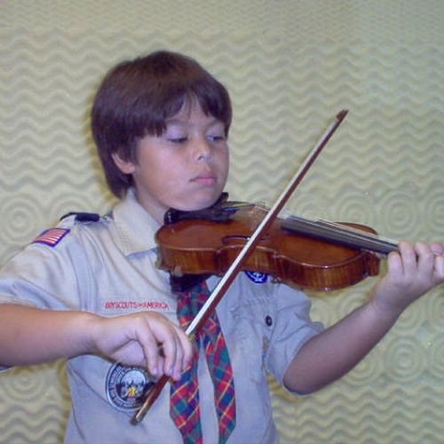 My violin student, a boy scout on his way to a cam