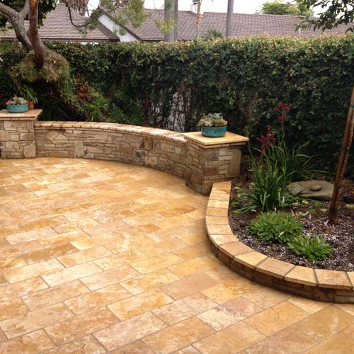 Concrete patio transformed with stone, seat wall a