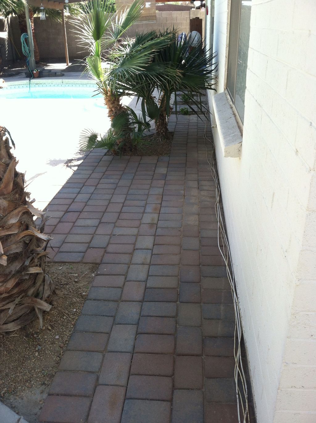 Paver installation around pool.