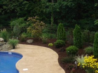 Floral and shrub plantings; mulch and rock waterfa