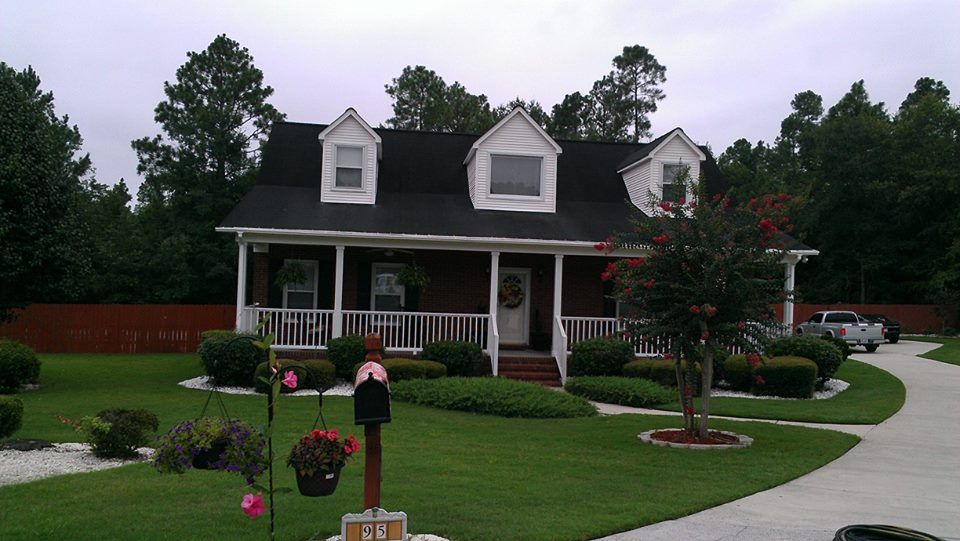brick, vinyl, driveway, and porch