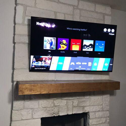 75” with hidden wires over stone fireplace