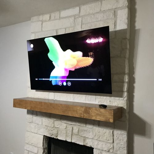 75” with hidden wires over stone fireplace 