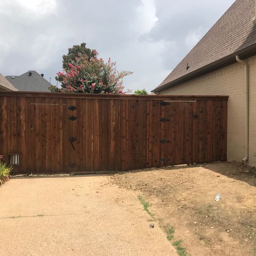 Built shared 6 ft board-on-board cedar fence with 