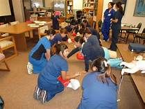 Students learning Adult, Child and Infant CPR and 