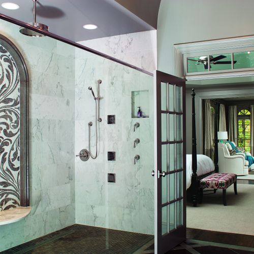 A roomy, glass-enclosed, curbless shower turns thi