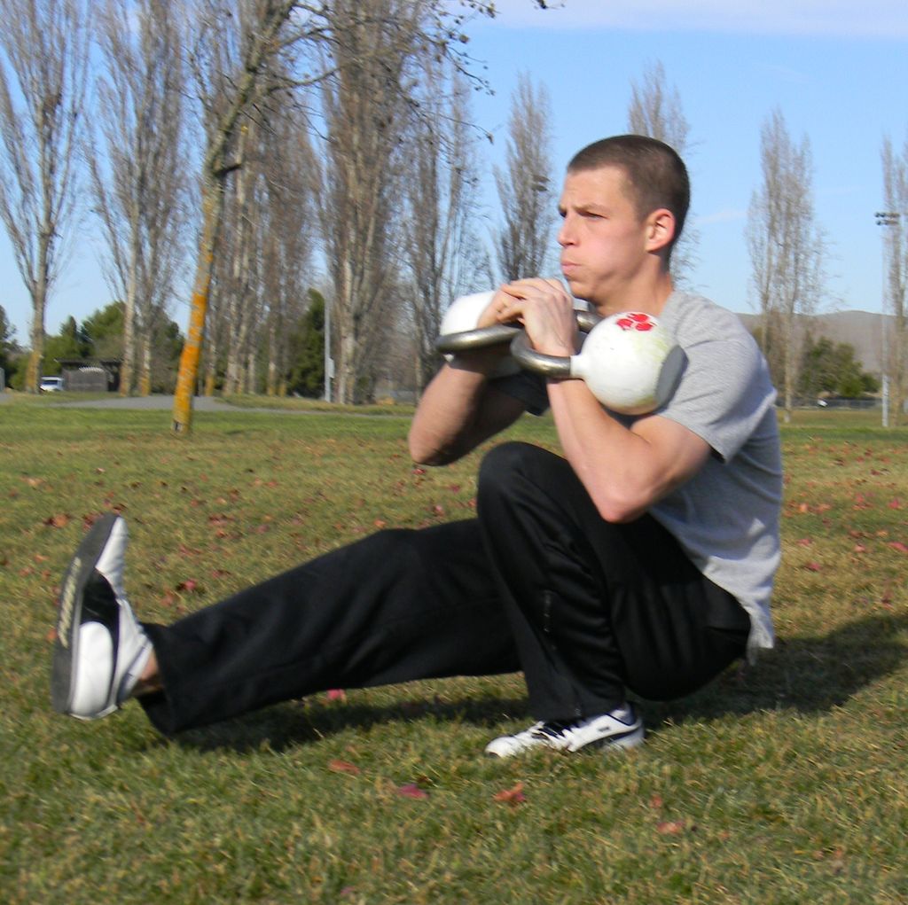 Jeff performing the pistol squat with 2x 30 lb ket