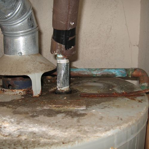 Leaking gas water heater beyond its design life.