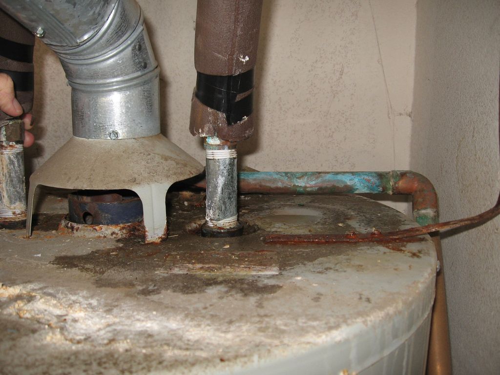 Leaking gas water heater beyond its design life.