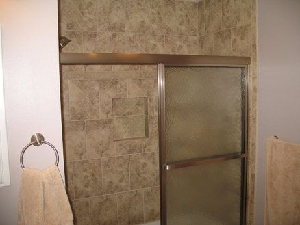 Tiled shower with insert for toiletries and glass 