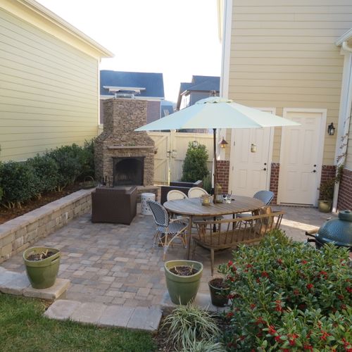 Outdoor living space with brick pavers, natural st