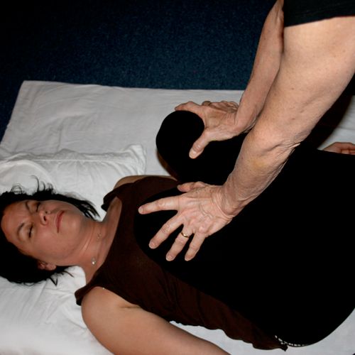 Thai Massage, stretching the lower back.