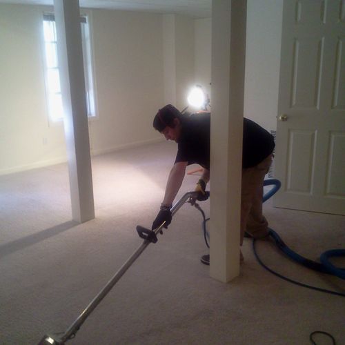 And employee performing a carpet cleaning on a mov