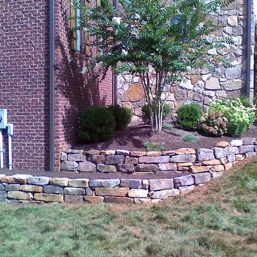 Dry-stacked stone walls ranging from 8 inches to 5