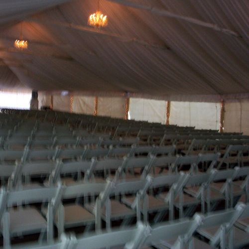500 guests seated in a tent for a fall wedding cer
